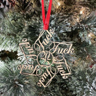 Decorative ornament with cursive text on a Christmas tree. The year 2015 is in the center and all the snowflake designs around the outside say the word "fuck"