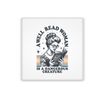 magnet with a graphic of a woman reading a book and text 'A well-read woman is a dangerous creature' on a white background.