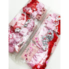 Packaged sets of hair scrunchies in pink and red with heart patterns. Labels read "Princess Accessories" for a cute, playful style.