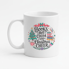 White mug with Christmas-themed design featuring text and festive elements on a white background.  It says, "Books, Hot Cocoa, & Christmas Cheer"