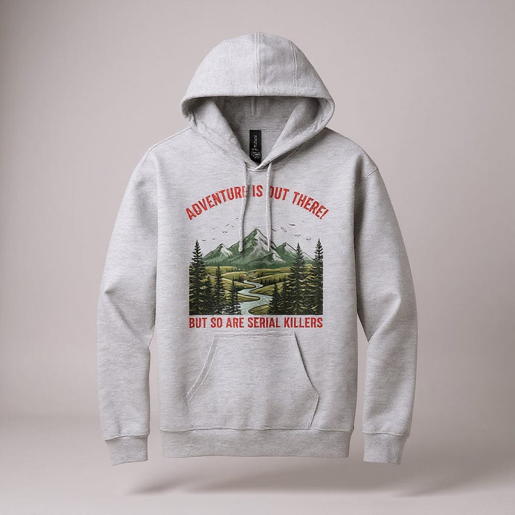 Gray hoodie with a graphic design of a mountain and trees, featuring text on a white background. Image reads "Adventure is out there but so are serial killers"
