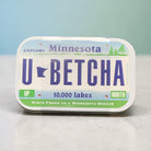Mint tin that looks like Minnesota License Plate that states “U Betcha!”