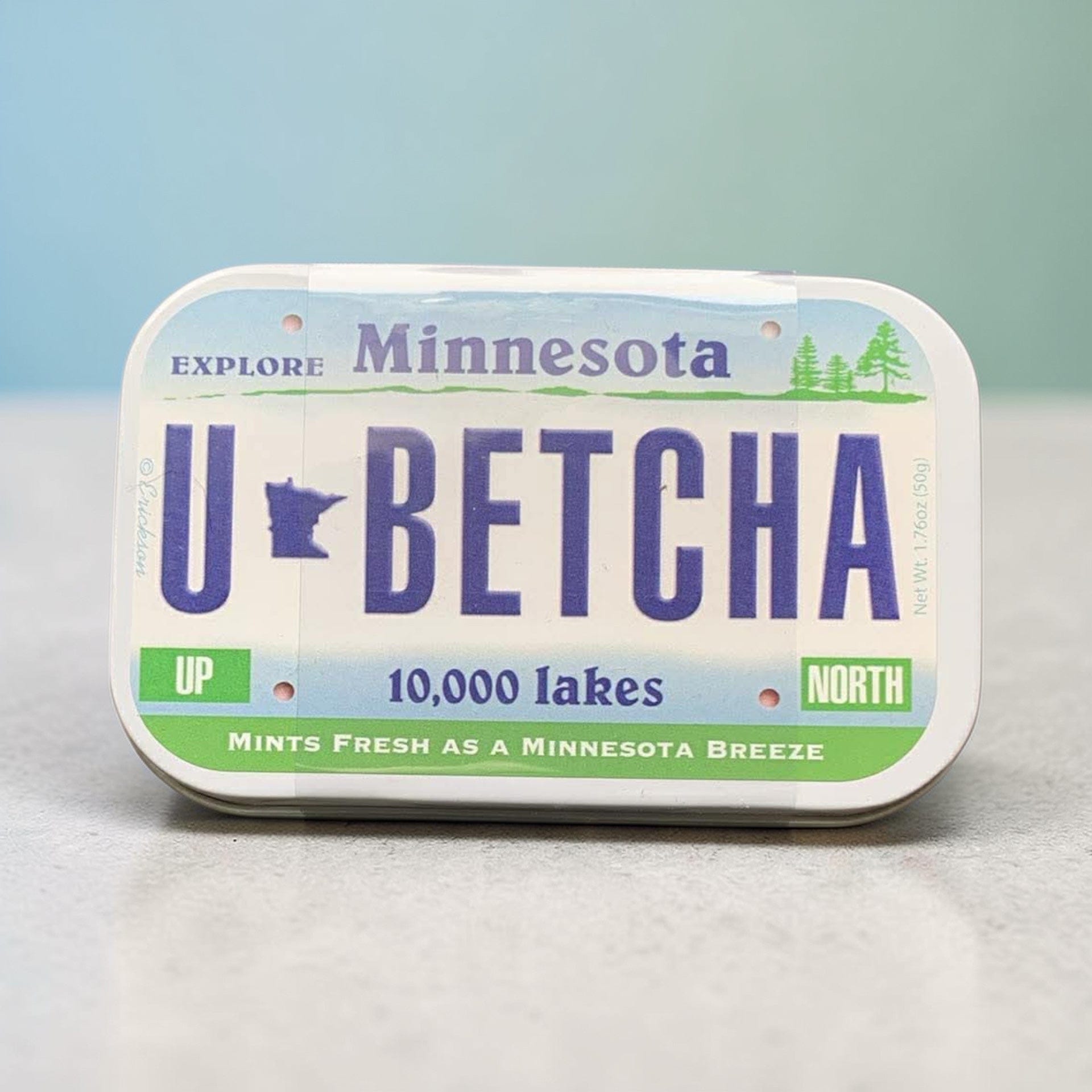 Mint tin that looks like Minnesota License Plate that states “U Betcha!”
