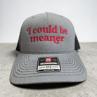 A gray Richardson 112 trucker hat with red embroidered text reading 'I could be meaner' on the front, shown against a neutral gray background.