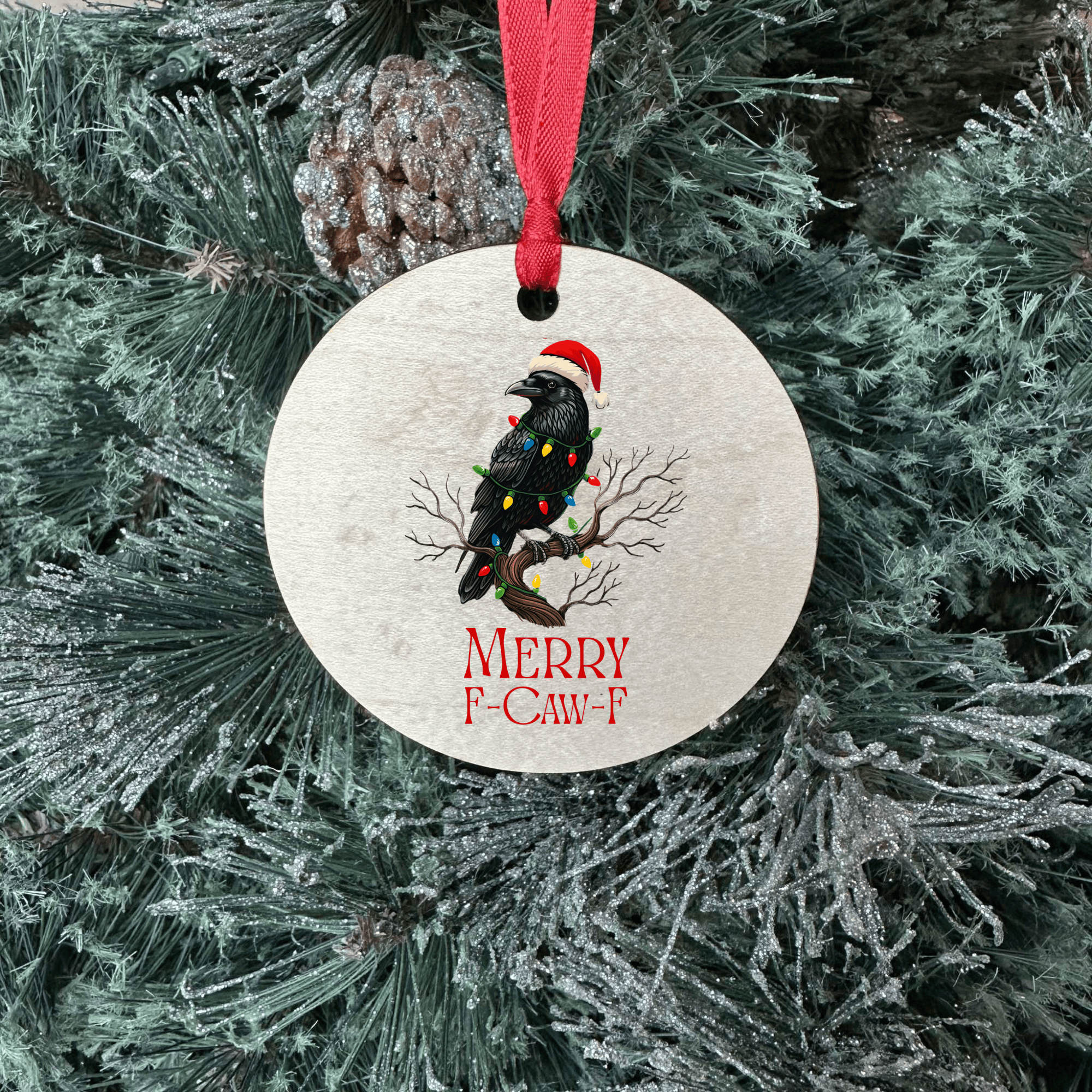 Round Christmas ornament with a bird and lights design on a tree.