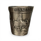 Bronze shot glass with 'MINNESOTA' text and nature design on a white background