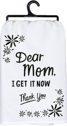 A black and white cotton kitchen towel featuring a "Dear Mom, I Get It Now Thank You" sentiment with floral designs.