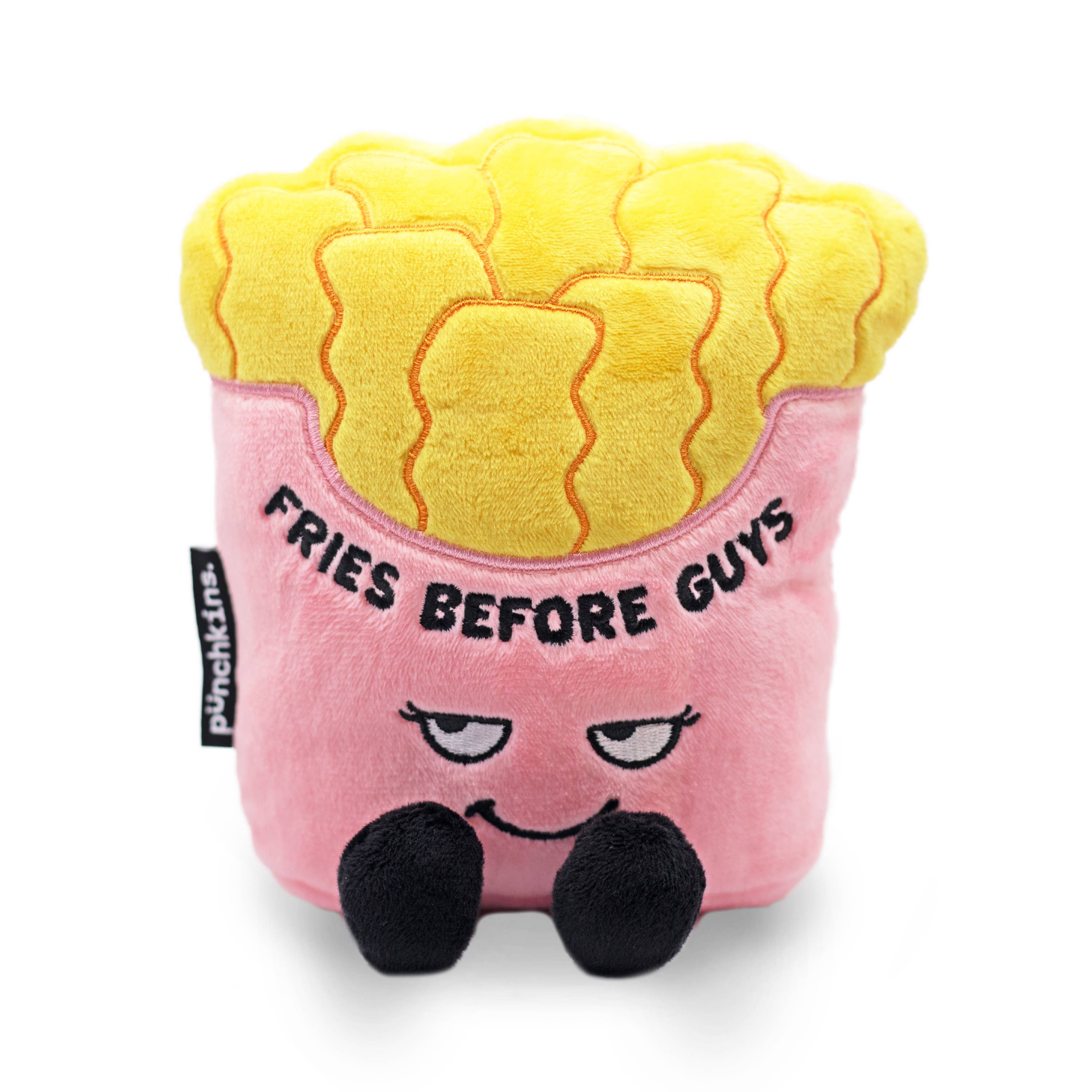 A pink fries container holding yellow fries. The pink section has a sly smiley face and black text that says "Fries before guys." The plushie has black legs sticking out.