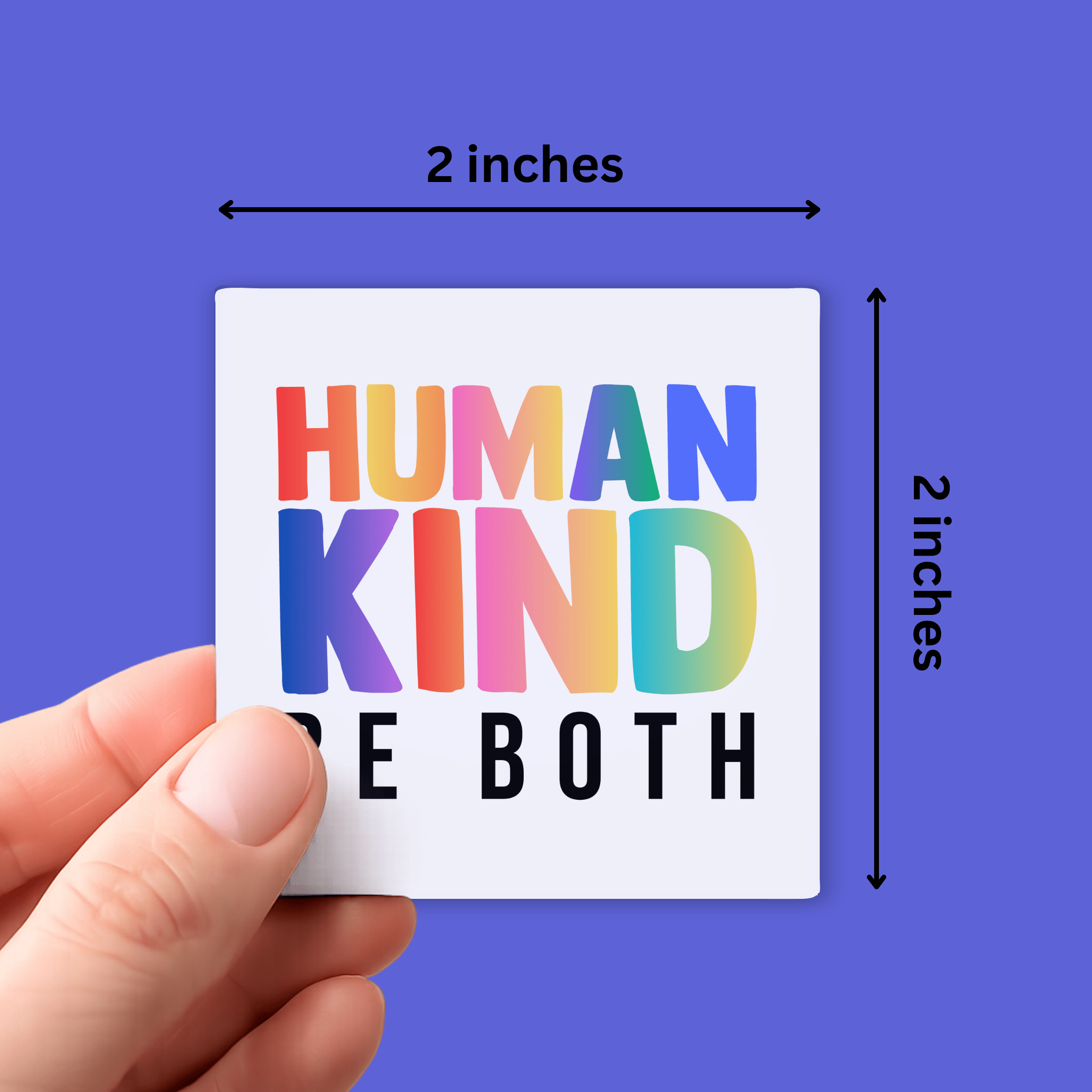 Hand holding a small square sticker with colorful text against a blue background