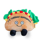 Taco-shaped stuffed animal with a smiling face, black feet, and green lettuce peeking out. The plushie features the phrase 'It’s Tuesday Somewhere' embroidered on it.