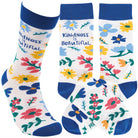 Pair of socks with colorful flowers that say "Kindness is beautiful" in blue text.