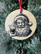 Wooden ornament with a printed design of Santa Claus on a Christmas tree.