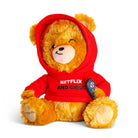 Brown teddy bear wearing a red sweatshirt with the hood up, ears sticking out the top. The bear is holding a remote and sporting a smirk. The sweatshirt features black and white embroidered text that reads 'Netflix & Chill.'