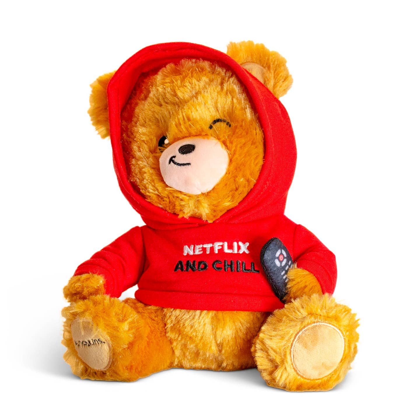 Brown teddy bear wearing a red sweatshirt with the hood up, ears sticking out the top. The bear is holding a remote and sporting a smirk. The sweatshirt features black and white embroidered text that reads 'Netflix & Chill.'