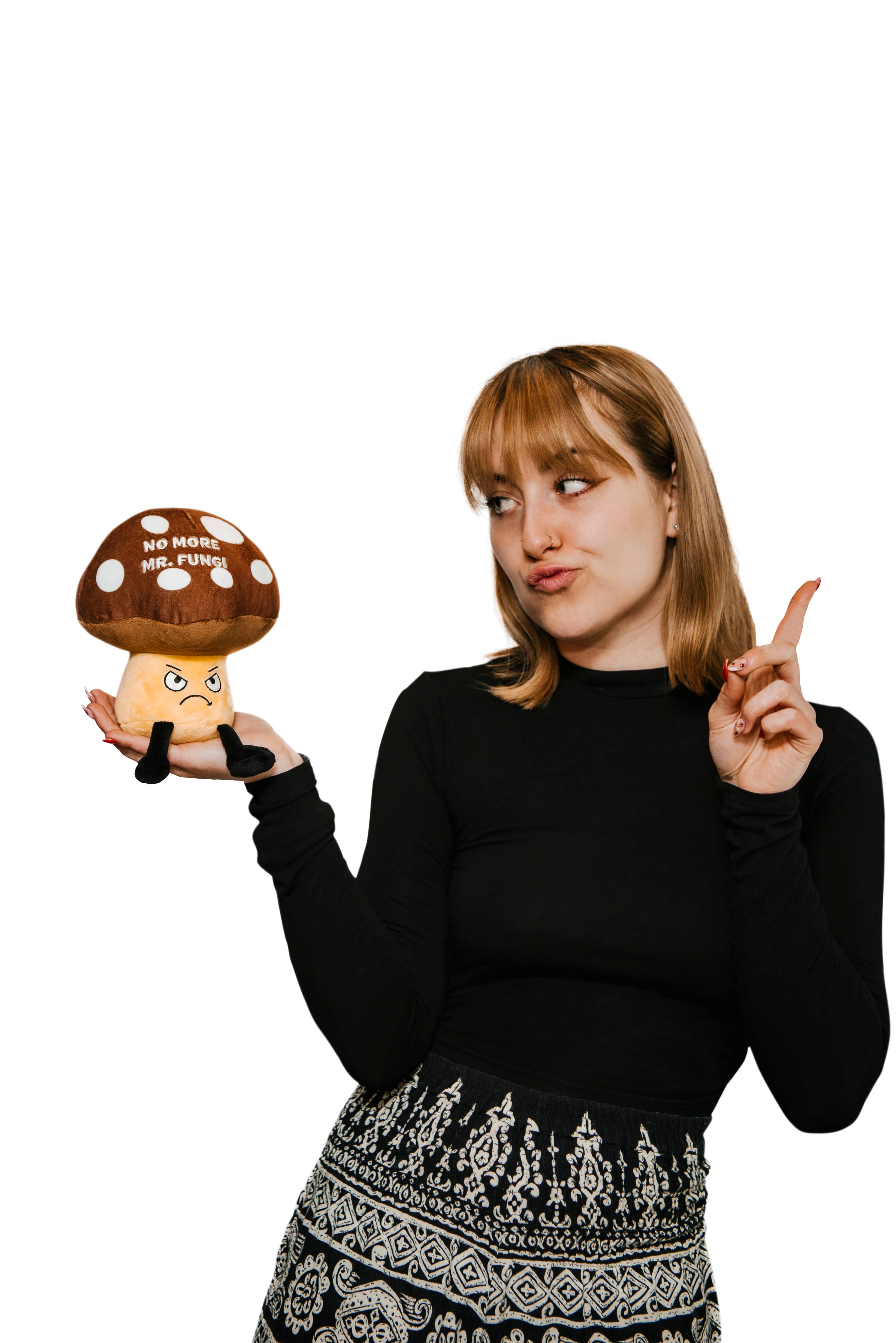 Girl holding an angry mushroom plush with a puffy cap and dangly legs. The mushroom has angry eyes and a frown, looking ready to throw its morels out the window. Its cap features brown and white polka dots, with white text that says "No more Mr. Fungi." The plush has a fun and humorous design, making it perfect for mushroom lovers and collectors.