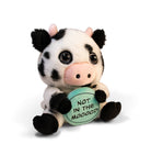 A black and white cow plush with pink horns, a pink nose, and glass eyes. The plush is holding a green plate with black text that reads 'Not in the Mooood,' giving it a playful and expressive look.