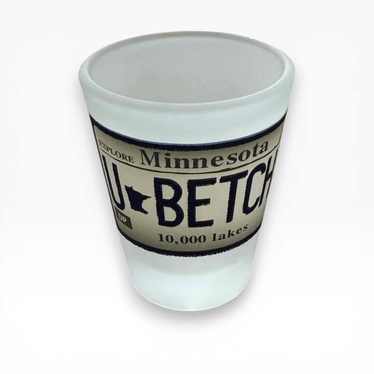 shot glass with Minnesota-themed text and design on a white background. Design looks like a Minnesota License Plate that states "U Betcha"