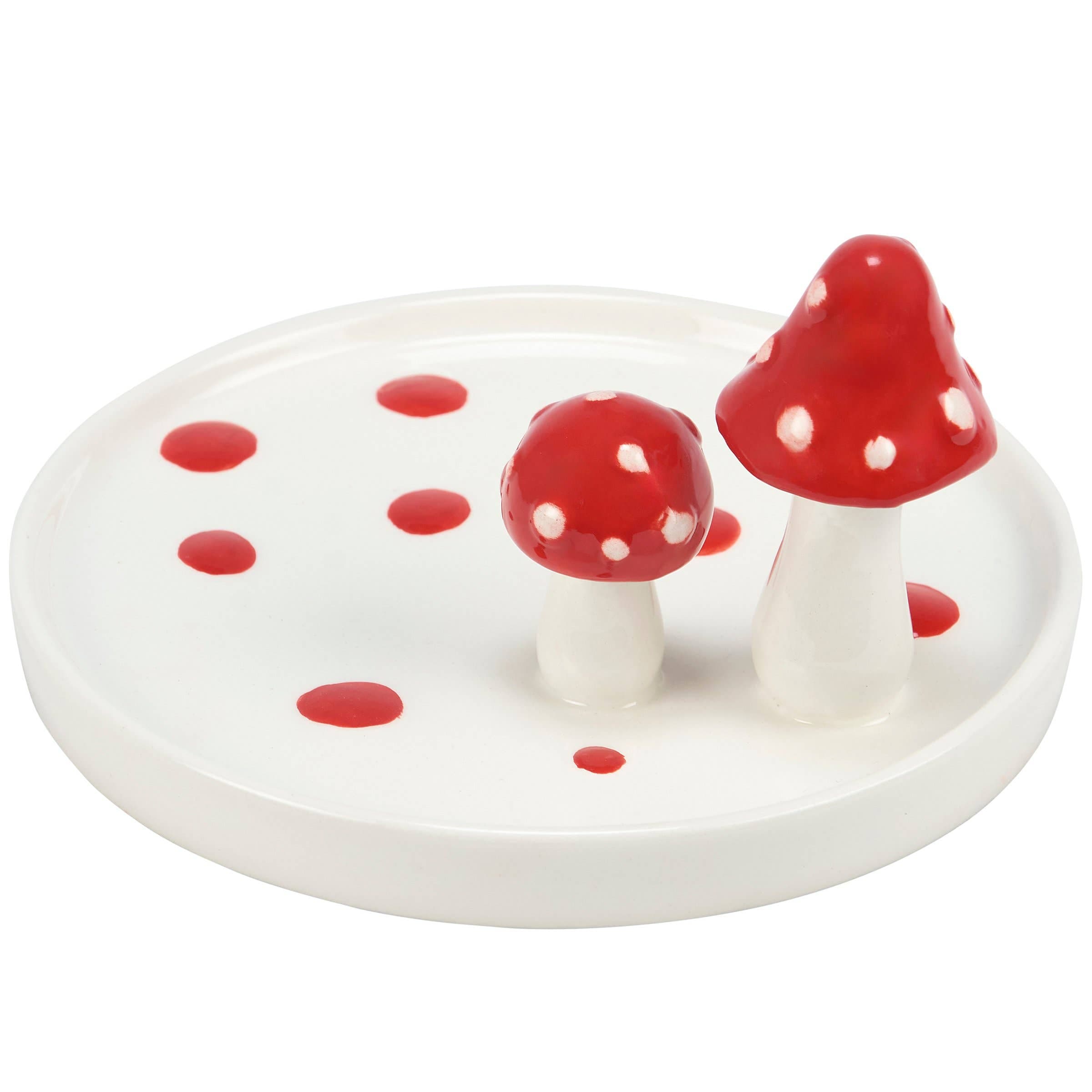 Ceramic jewelry tray shaped like a white plate with two red and white polka-dotted mushrooms. It has scattered red dots, giving a whimsical feel.