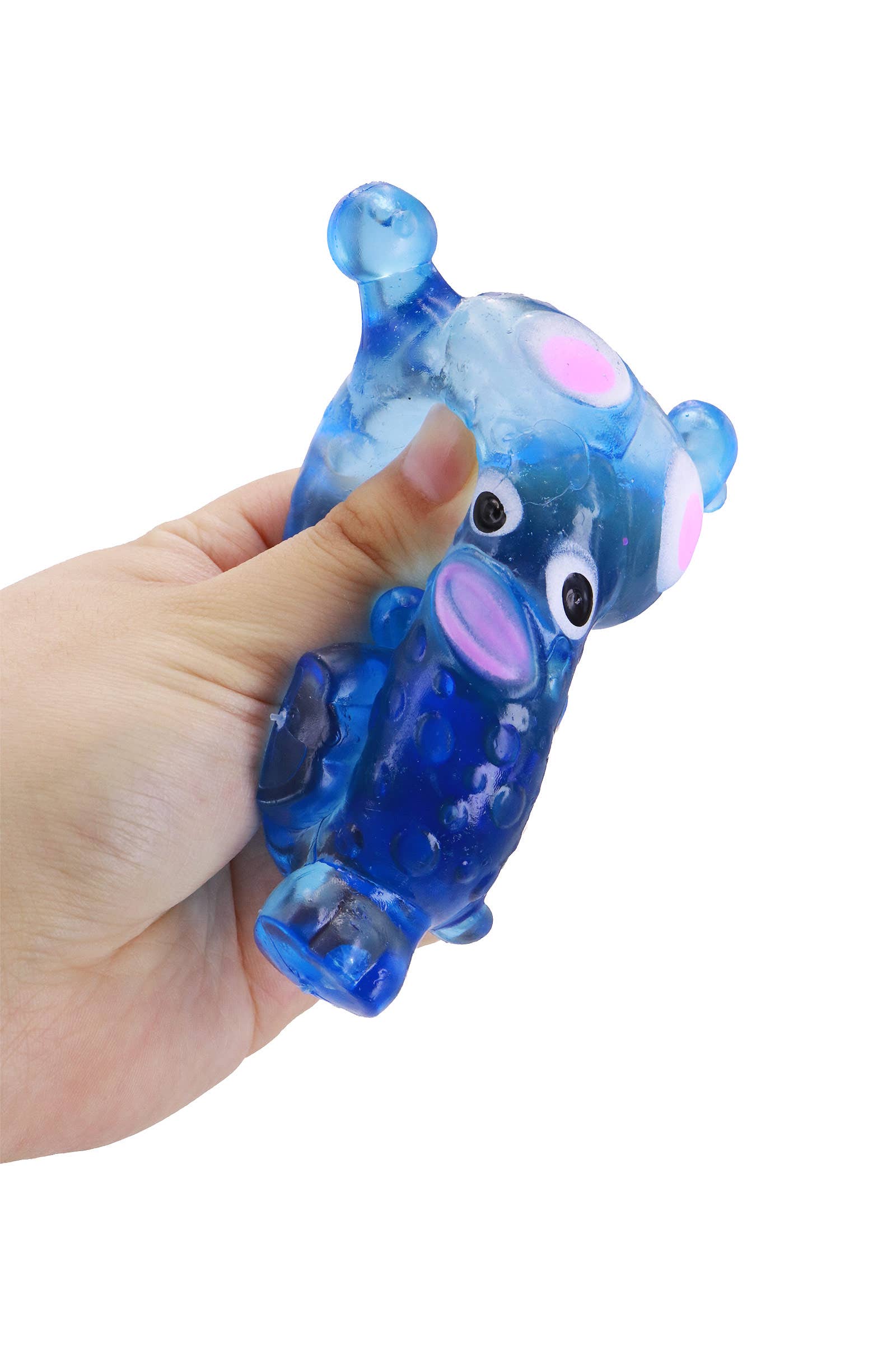 Hand holding a blue and pink toy figure against a white background