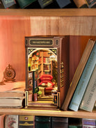 Miniature model of a bookshelf with a cozy interior, resembling a famous author's house, on a wooden shelf. Perfect for adding charm to your bookshelf in between your favorite books.