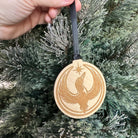 Side view of the Rebel Loon wood ornament on a Christmas tree