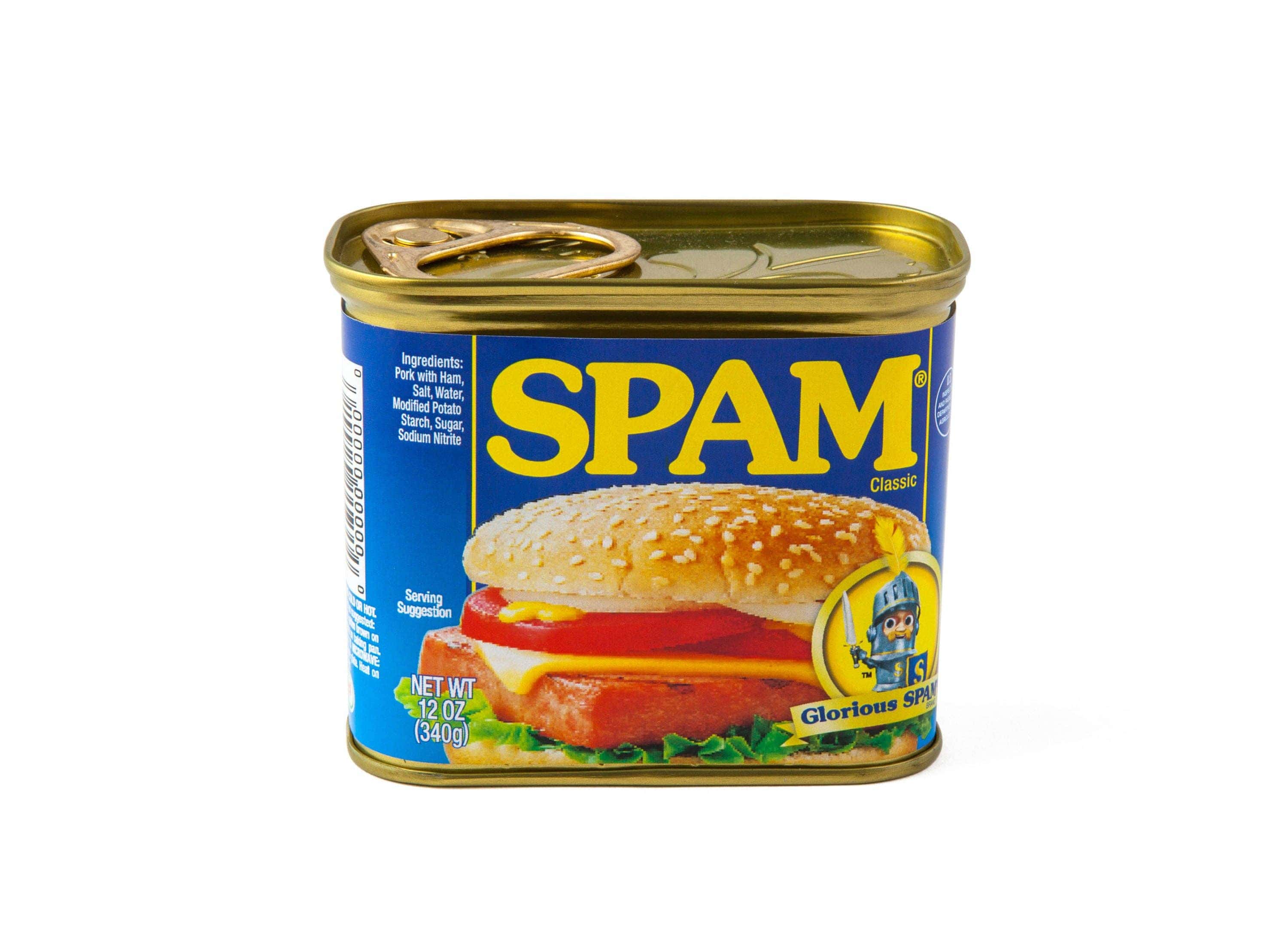 A can of Spam Classic with a blue label, featuring a sandwich topped with a sesame seed bun. The Spam text is bold in yellow, evoking a nostalgic feel.