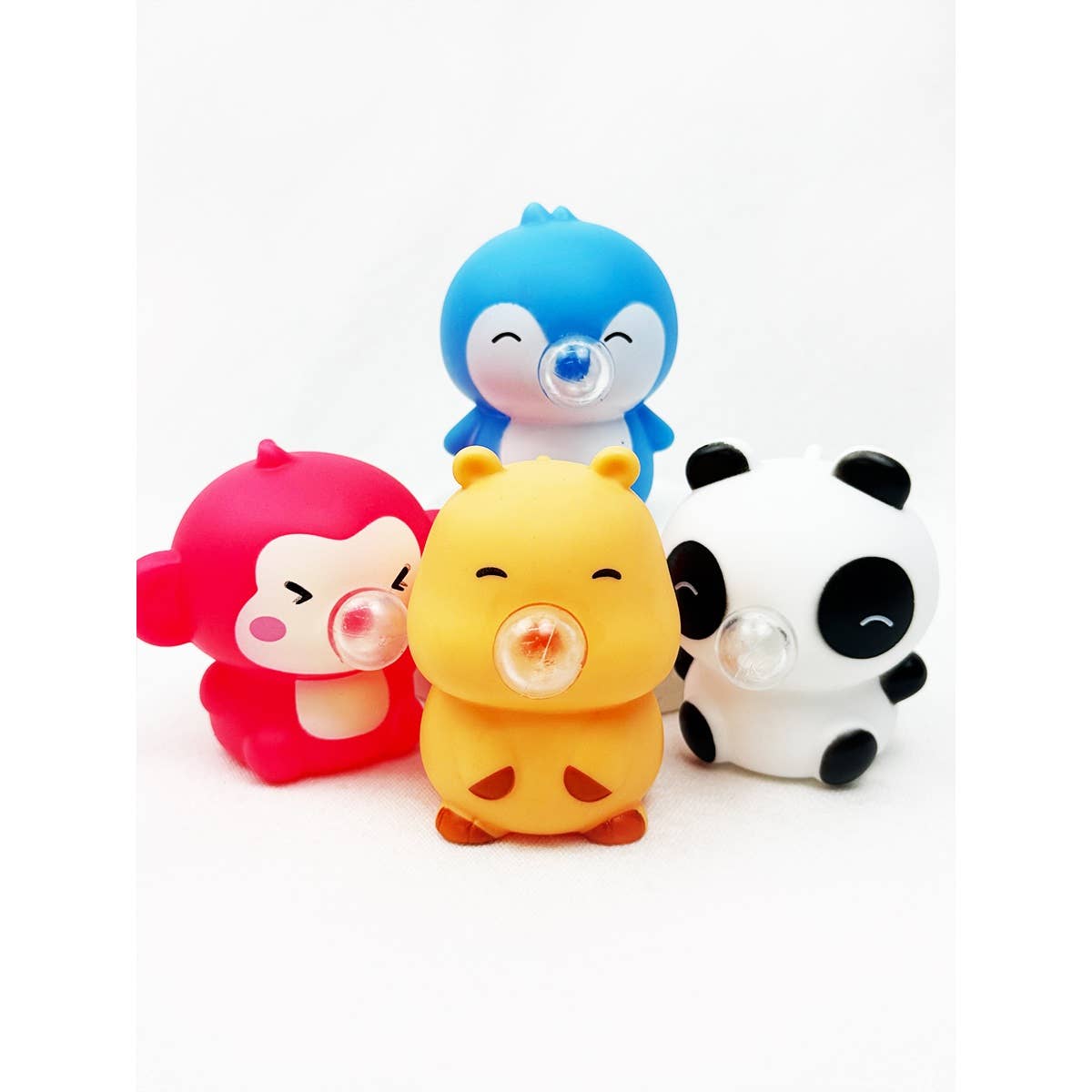 Four cute animal character squishy toys, including a red monkey, blue penguin, yellow hamster, and a panda, each blowing a clear, translucent bubble from their mouths.