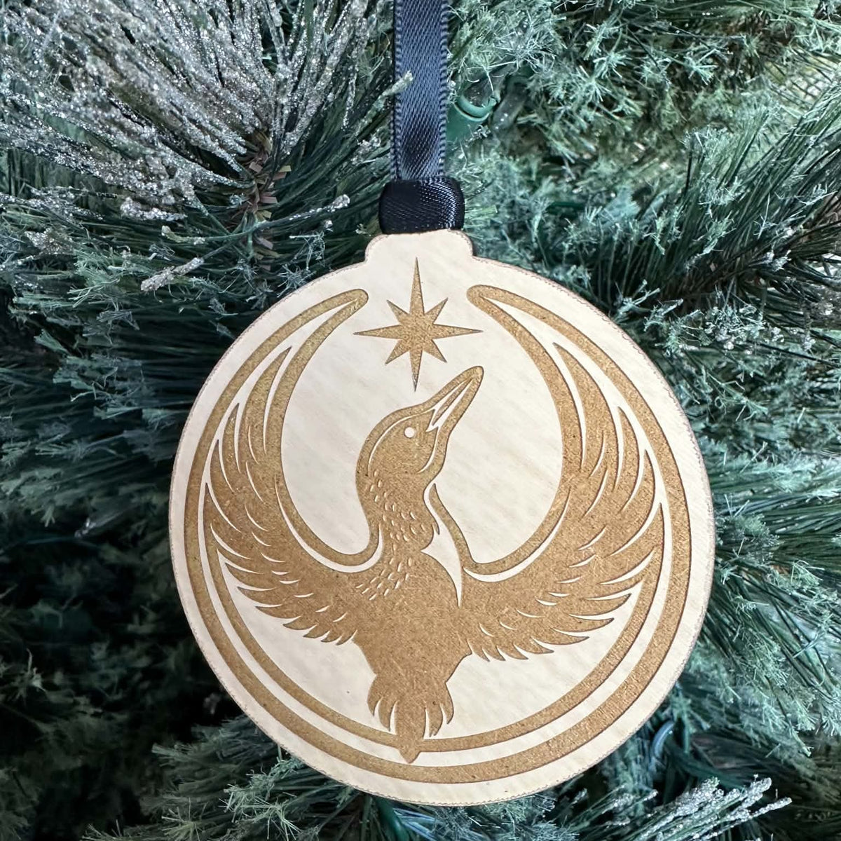 Close-up of the engraved Rebel Loon design with raised wings and a star