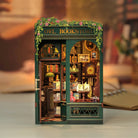 Miniature model of a bookshop named 'Owl Bookstore' with detailed interior. Made for sittng on a bookshelf.