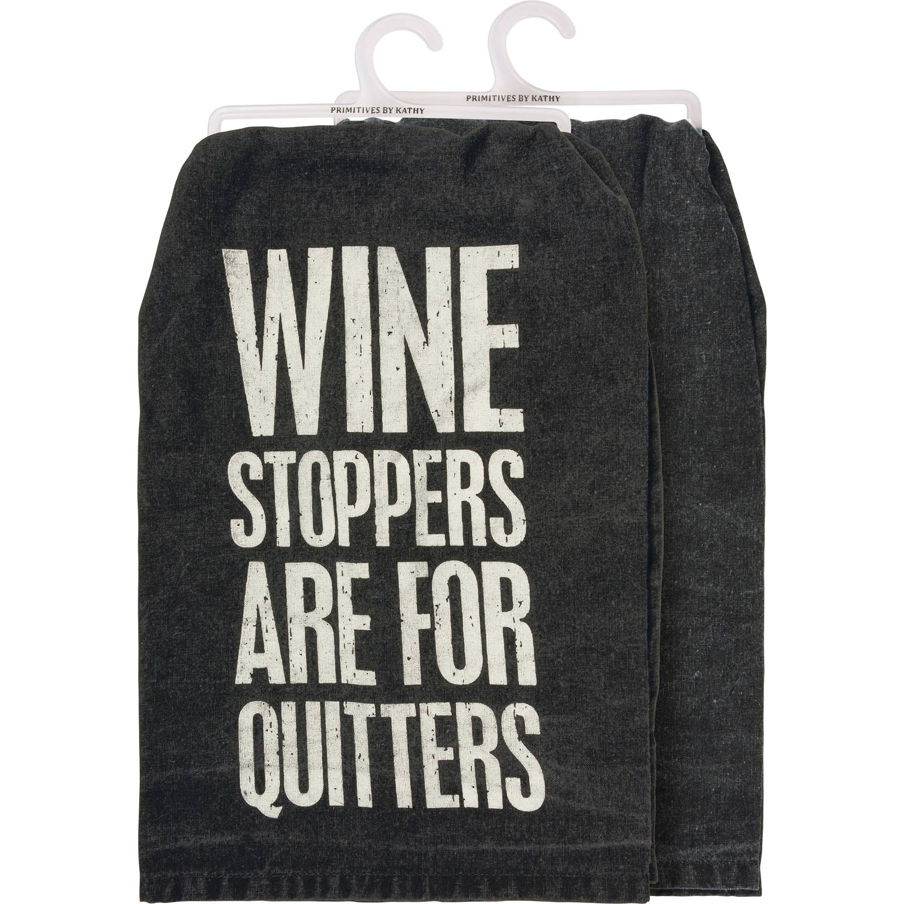 Dark kitchen towel with bold white text saying "Wine stoppers are for quitters." Humorous tone, displayed folded, hanging on dual hooks.