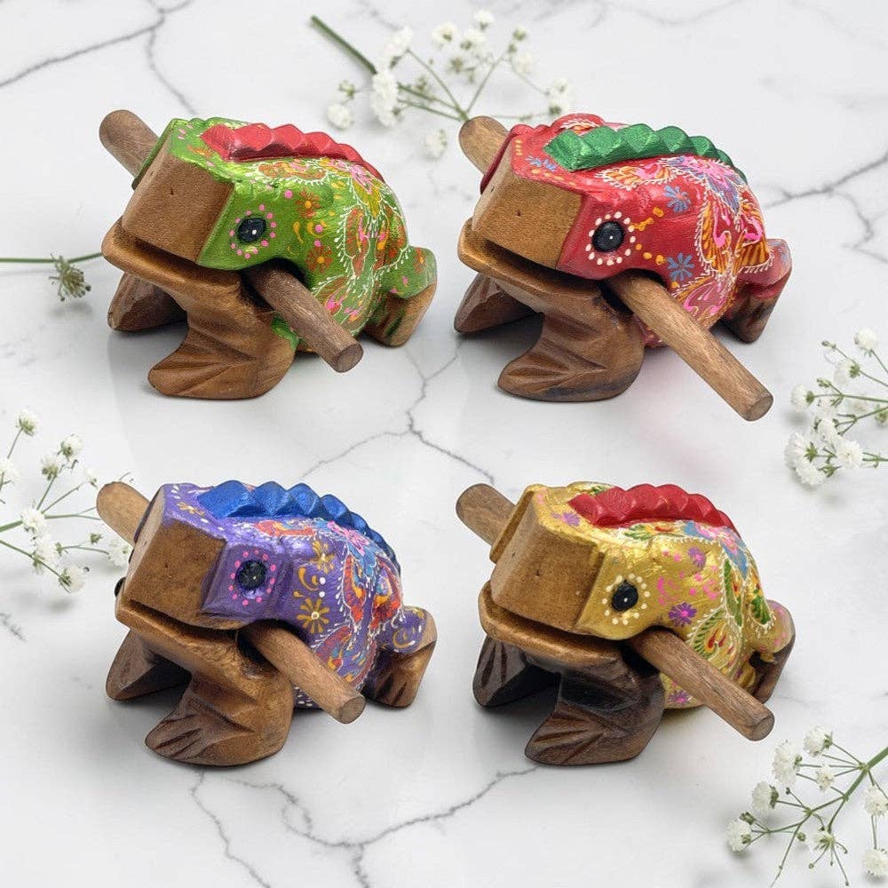 Four handcrafted wooden toy frogs that works as a musical instrument 