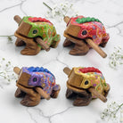 Four handcrafted wooden toy frogs that works as a musical instrument 