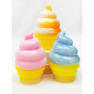 Three soft-serve ice cream cone squeeze squishy toys in pink, blue, and orange/white swirl colors with yellow bases.