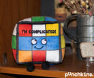 A rainbow puzzle cube plushie with a smiley face and black text that says "I'm complicated." The plushie has black legs sticking out.