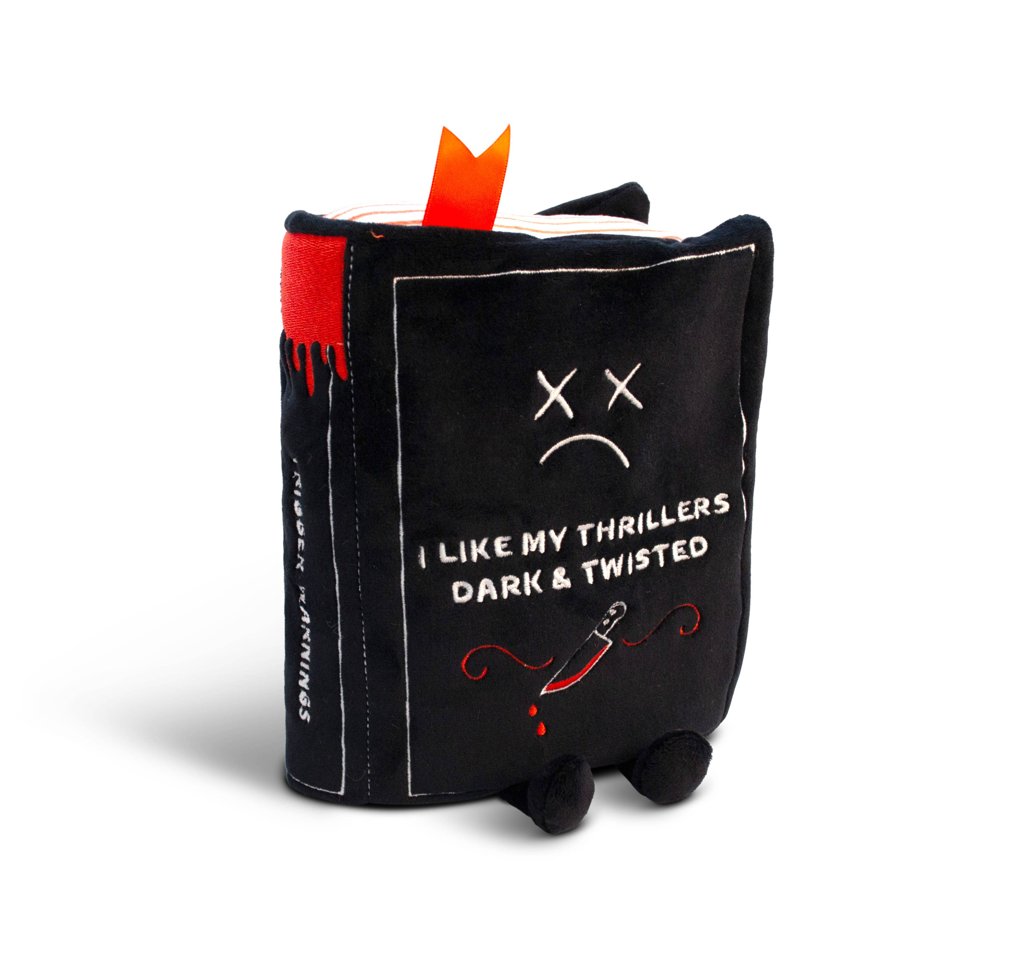 A black plush book with a sad expression and X-shaped eyes. White embroidered text reads, "I like my thrillers dark and twisted." A bloody knife detail is at the bottom, with black legs sticking out underneath and a red bookmark peeking from the top.