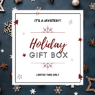 A festive holiday gift box with the text 'It's a MYSTERY! Holiday Gift Box' on a background decorated with Christmas decorations like snowflakes, stars, and holiday ornaments. The text 'Limited Time Only' is also present.